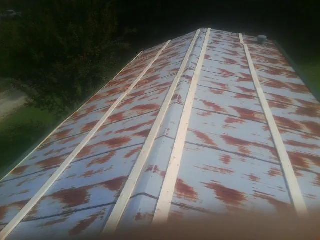 Rusted metal roof panels with new wood purlins before replacement — Storm Damage Roof Repair in Carmine by Roofing Brothers
